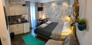 a small bedroom with a bed and a kitchen at Apartments Lov in Budva