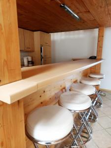 a bar with stools in a kitchen with a counter at Pension Forstgut Waldeck in Ingelheim am Rhein