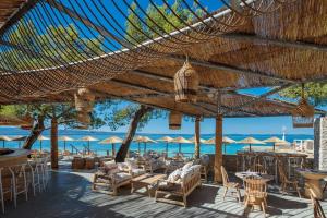 a patio with chairs and tables and umbrellas at Bubbles Penthouse with Jacuzzi in Podstrana