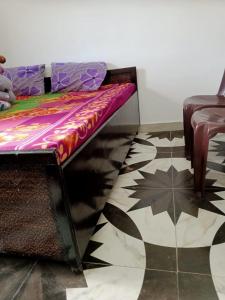 a bench sitting in a room with a floor at Krishna Homestay Nohradhar in Tārna