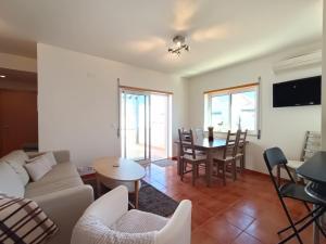 a living room with a couch and a table at Quinta Gomeira by Amandio Batista in Cabanas de Tavira