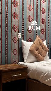 a bedroom with a bed with a red and white wallpaper at Rum desert magic in Wadi Rum