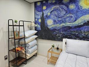 een slaapkamer met een schilderij van de sterrenhemel bij Stary Night at Hwagok - Gimpo Airport in Seoul