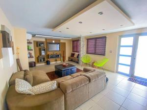 a large living room with a couch and a tv at Blue Paradise - - Fajardo, PR in Fajardo