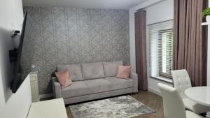 a living room with a couch and a table at APARTAMENT JARACZA 28/14 in Słupsk