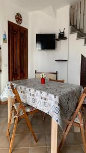 a table with a table cloth on it in a room at Villetta bordo piscina vista mare Wi-Fi Gratis in Nebida