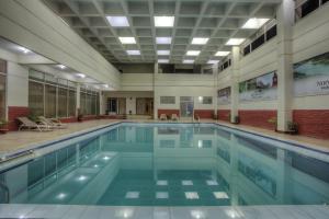a large swimming pool in a building at Nirvana Inn in Sylhet