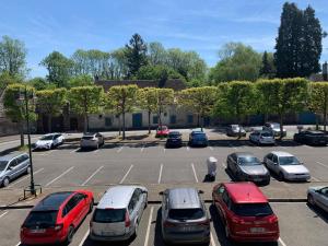 a parking lot with several cars parked in it at Chambres Senonches centre-ville in Senonches