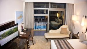 a hotel room with a bed and a television at Tang Palace Hotel in Accra