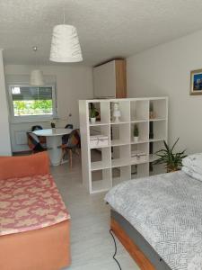 a bedroom with a bed and a desk and a table at Jakov & David in Gospić