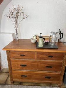 a wooden dresser with a vase on top of it at Zimmer auf dem Scheuerhof in Wittlich