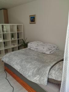 a bed in a white room with a bed frame at Jakov & David in Gospić