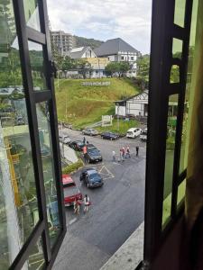 a view from a window of a parking lot at Jarzmin 3 Bedroom Apartment in Tanah Rata