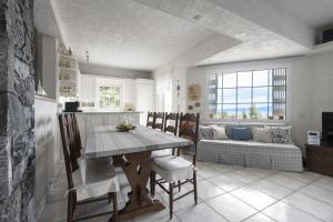a kitchen and dining room with a table and a couch at Paliouri Cottage by Luxlikehome in Paliouri