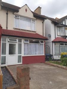 a white and red house with a red roof at 4 Bedroom Edwardian House with Ensuite, Garden & Parking in Thornton Heath
