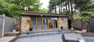 a small stone building with a table and chairs at Dean Clough Lodge - Contemporary self contained studio in Wilpshire