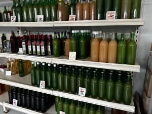 a store shelf filled with lots of wine bottles at Odmorište Vrelo Vape in Sjenica +11 photos