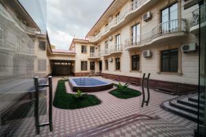 a building with a pool in the middle of a courtyard at ZAAL Hotel in Samarkand