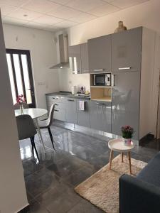 a kitchen with a table and a dining room at Apartman Daisy in Slatine