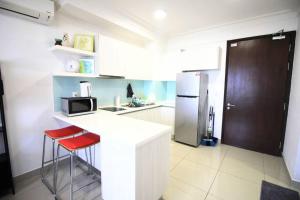 a kitchen with a white counter and a refrigerator at [New Listing Promo] Short Stay Condo @ Cyberjaya in Cyberjaya