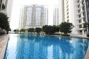 a large blue swimming pool in front of tall buildings at [New Listing Promo] Short Stay Condo @ Cyberjaya in Cyberjaya
