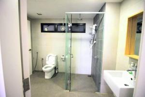 a bathroom with a shower and a toilet and a sink at [New Listing Promo] Short Stay Condo @ Cyberjaya in Cyberjaya