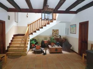 a living room with stairs and potted plants at Casa sobre el mar 10 personas in Mutriku