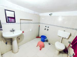 a bathroom with a sink and a toilet at Raadballi Retreat in Kangra +42 photos