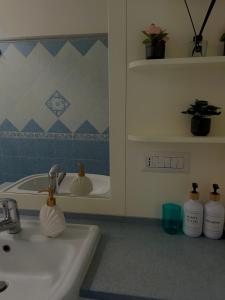 a bathroom with a sink and a mirror at Capri Suite Dreams in Capri
