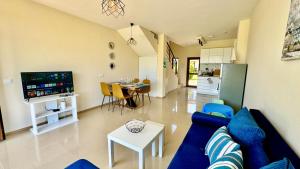 a living room with a blue couch and a table at Boutique House Blue Lagoon by Flat Mаnаger in Balchik