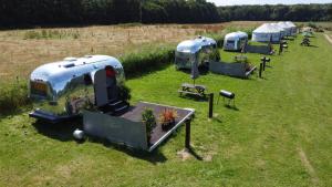 a group of camels parked in a field at Silver Airstream Glamping & Rental in Chichester