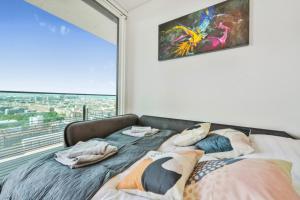 维也纳Luxury Penthouse I Rooftop Pool I Self Check-in的窗户间内的一张带枕头的床 更多29张照片