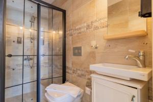 a bathroom with a shower and a toilet and a sink at Das Hotel Alacati in Alaçatı +150 photos