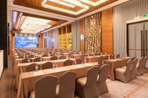 a large room with rows of tables and chairs at Jinjiang Metropolo Hotel - Shenzhen Longgang Central City Longcheng Plaza in Longgang