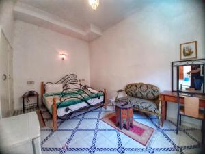 a living room with a bed and a couch at Residence Koutoubienne in Marrakesh +47 photos