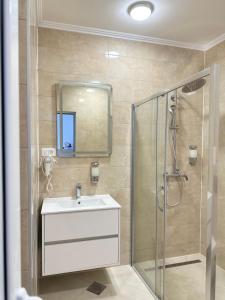 a bathroom with a sink and a shower at Villa Milan in Sveti Stefan