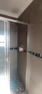 a shower with a glass door in a bathroom at eSunvalley Guest House in Roodepoort