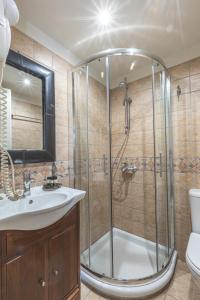 a bathroom with a shower and a sink at Arethousa Hotel in Katakolon