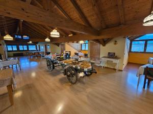 a large room with a cart with food on it at Antico Fienile Agritur in Mezzocorona