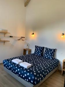 1 dormitorio con 1 cama azul con lunares blancos en Gîte pour 4 personnes - Le Grand Valtin, à 2 pas de Xonrupt, en Ban-sur-Meurthe-Clefcy