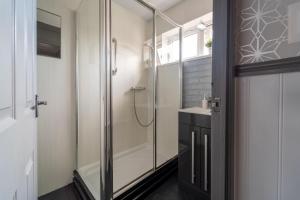a bathroom with a shower and a sink at Spacious 3 Bed House, 5mins to HS2/ NEC/Airport. in Marston Green +79 photos