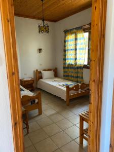 a small bedroom with a bed and a window at Betsanis Stafylos Apartments in Stafylos