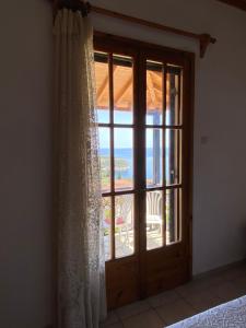a bedroom with a window with a view of the ocean at Betsanis Stafylos Apartments in Stafylos