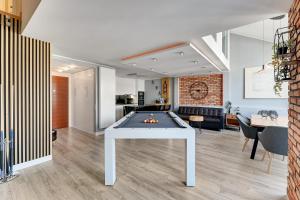 a living room with a ping pong table at Waterlane by Vivendi Properties in Gdańsk