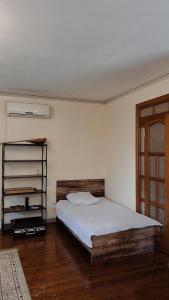 a bedroom with a bed and a book shelf at 长城民宿34号院 in Almaty