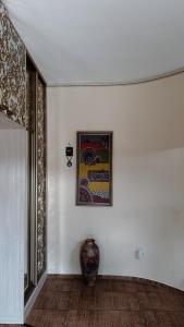 a room with a picture on the wall and a vase at 长城民宿34号院 in Almaty