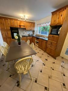 a kitchen with a table and chairs in it at Corrigs Retreat in Newcastle