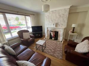 a living room with a couch and a fireplace at Corrigs Retreat in Newcastle