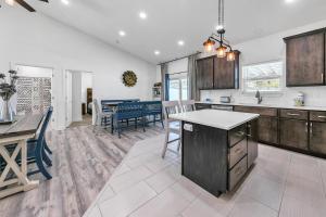 a kitchen and dining room with a table and chairs at Rustic Oasis in Panama City Beach