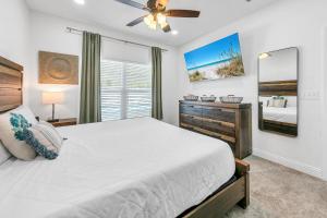 a bedroom with a bed and a ceiling fan at Rustic Oasis in Panama City Beach +40 photos